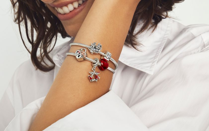 Woman wearing sterling silver bracelet with charms