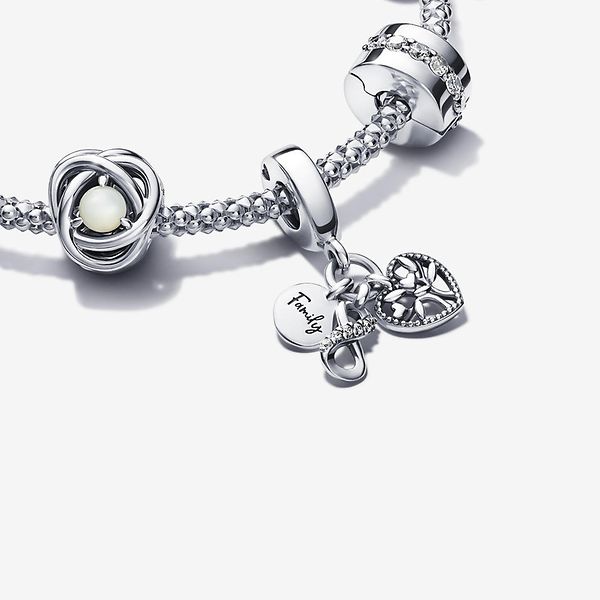 A silver bracelet and nine charms from the Just Because occasion collection