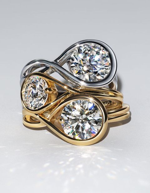 Image of 2 lab grown diamond rings, 1 silver and 1 gold, on top of each other