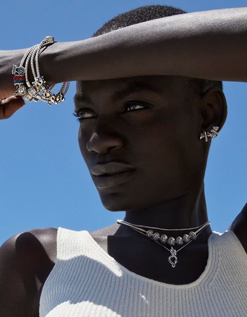 A woman in the sun, modelling Game of Thrones x Pandora jewellery.