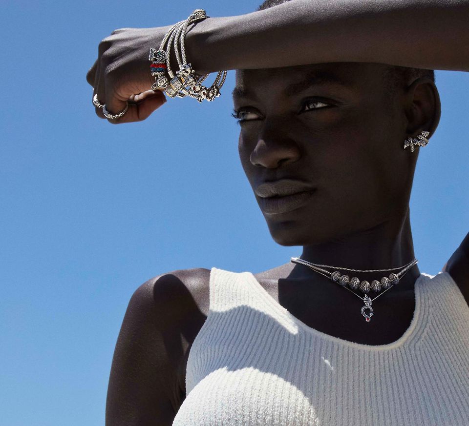 A woman in the sun, modelling Game of Thrones x Pandora jewelry.